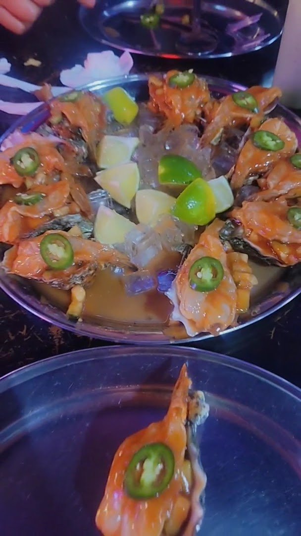 Shared plates of ceviche and tacos on display.