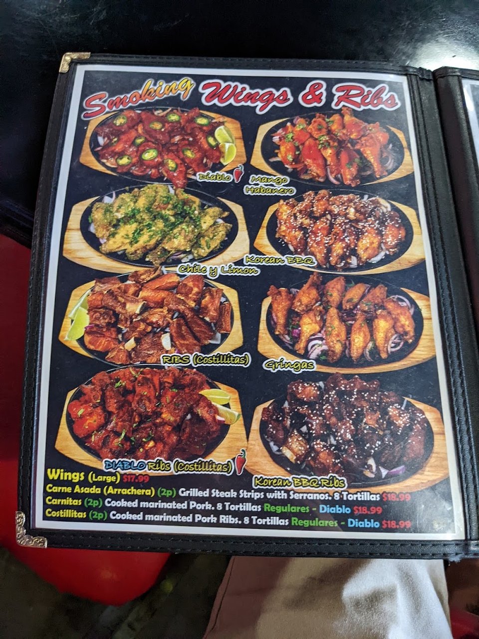 Close view of a restaurant menu with drink options.